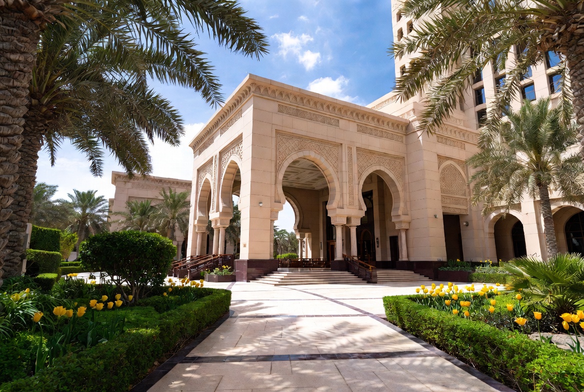 Luxurious hotel entrance in Muscat, Oman with elegant landscaping featuring vibrant yellow tulips and lush green gardens at Tulip Flowers client property